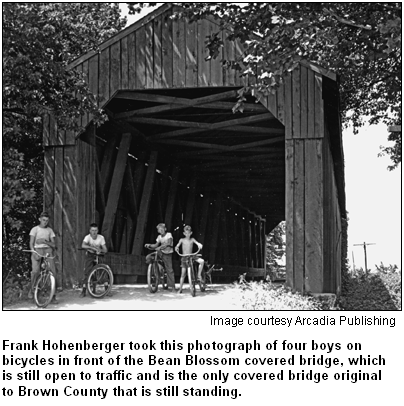 Frank Hohenberger took this photograph of four boys on bicycles in front of the Bean Blossom covered bridge, which is still open to traffic and is the only covered bridge original to Brown County that is still standing. Image courtesy Arcadia Publishing.