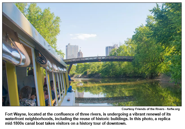 Fort Wayne, located at the confluence of three rivers, is undergoing a vibrant renewal of its waterfront neighborhoods, including the reuse of historic buildings. In this photo, a replica mid-1800s canal boat takes visitors on a history tour of downtown. 
Courtesy Friends of the Rivers.