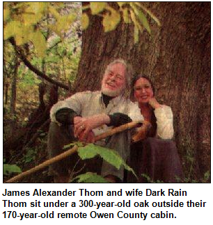 James Alexander Thom and wife Dark Rain Thom sit under a 300-year-old oak outside their 170-year-old remote Owen County cabin.