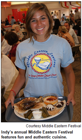 Smiling young woman with platter of food at Indy's Middle Eastern Festival.