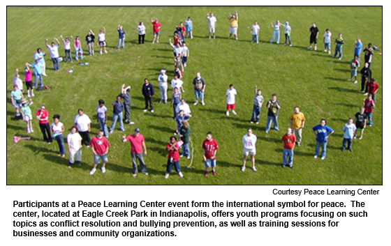 Participants at a Peace Learning Center event form the international symbol for peace.  The center, located at Eagle Creek Park in Indianapolis, offers youth programs focusing on such topics as conflict resolution and bullying prevention, as well as training sessions for businesses and community organizations.
Courtesy Peace Learning Center.