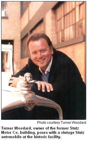 Turner Woodard, owner of the former Stutz Motor Co. building, poses with a vintage Stutz automobile at the historic facility.