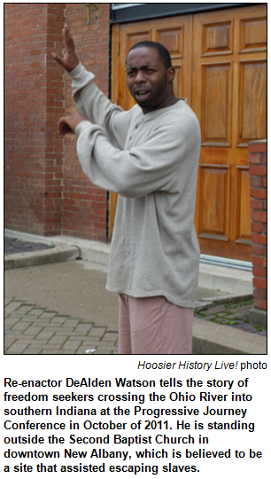 Re-enactor DeAlden Watson tells the story of freedom seekers crossing the Ohio River into southern Indiana at the Progressive Journey Conference in October of 2011. He is standing outside the Second Baptist Church in downtown New Albany, which is believed to be a site that assisted escaping slaves. Hoosier History Live! photo.