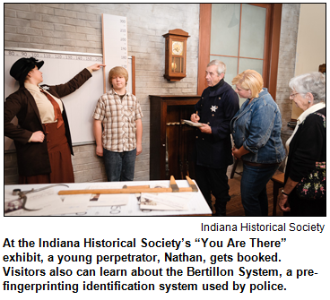 At the Indiana Historical Society’s “You Are There” exhibit, a young perpetrator, Nathan, gets booked. 